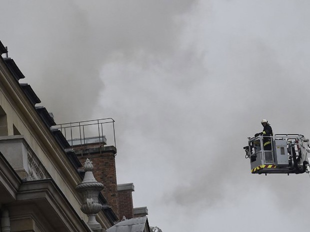 Bombeiro utiliza plataforma para conter chamas no último andar do luxuoso Hotel Ritz, em Paris, nesta terça-feira (Foto: Lionel Bonaventure/ AFP)